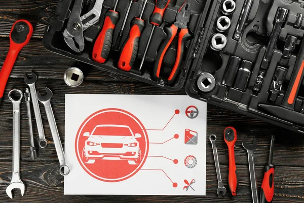 Papier met regeling en vak met tools voor auto reparatie — Stockfoto