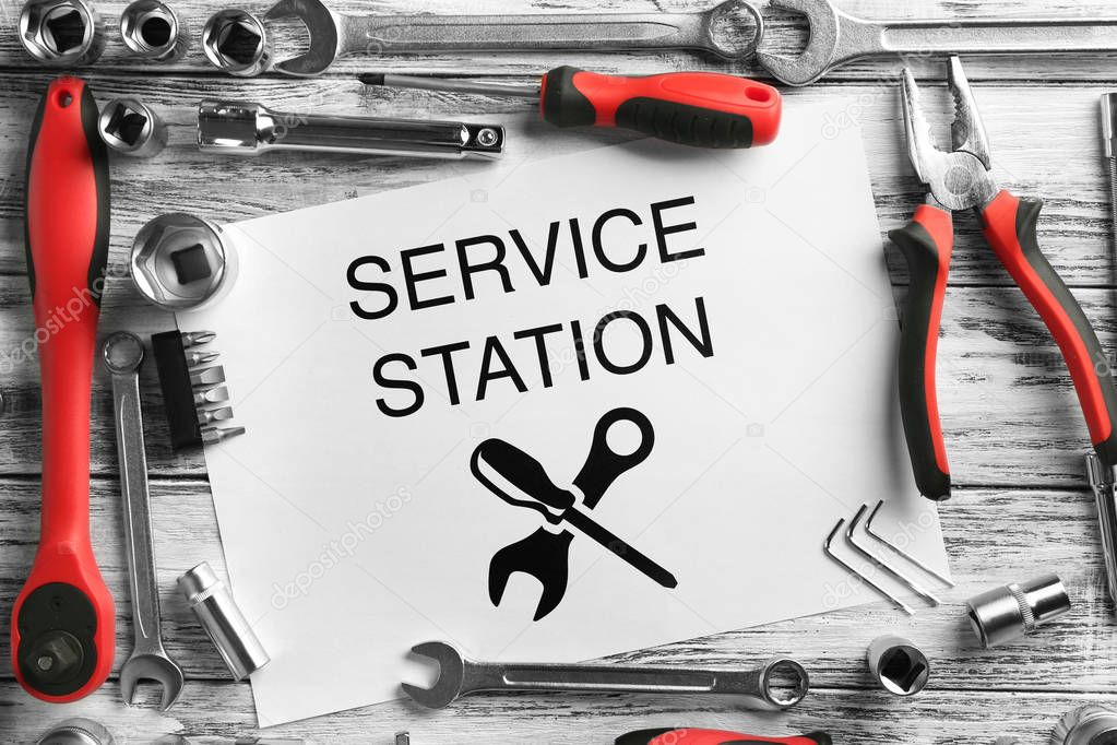 Paper with SERVICE STATION text and tools 