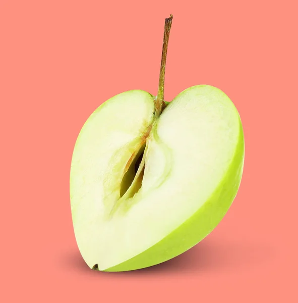 Heart shaped apple on color background