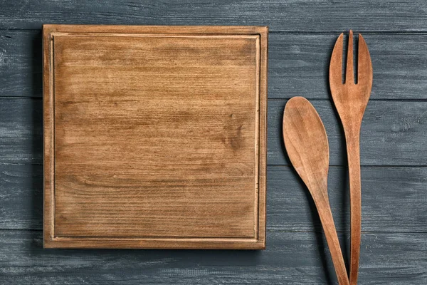 Wooden board and cooking utensils — Stock Photo, Image