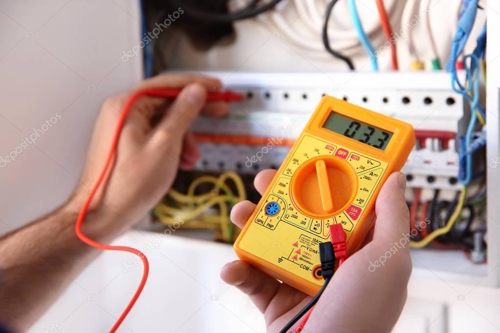 electrician measuring voltage