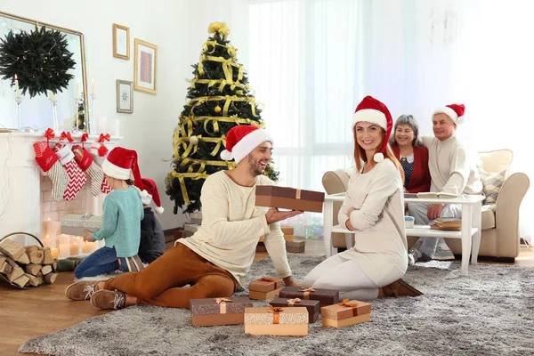 Family in living room decorated for Christmas