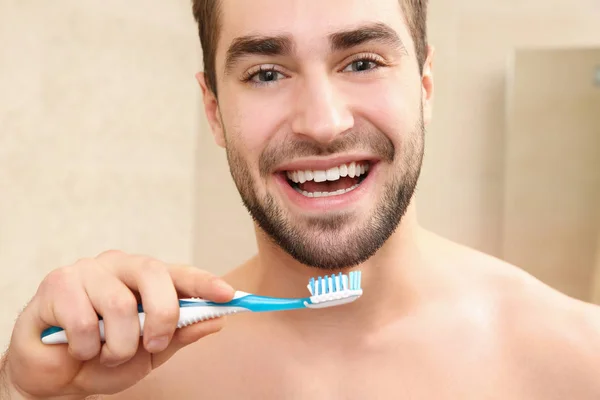 Hombre guapo cepillándose los dientes — Foto de Stock