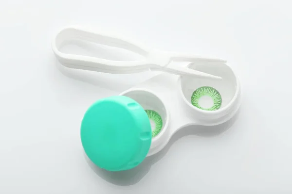 Container with green contact lenses — Stock Photo, Image