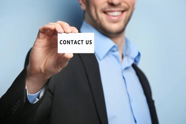 Young man holding business card — Stock Photo, Image
