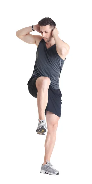 Handsome man doing bicycle crunch — Stock Photo, Image