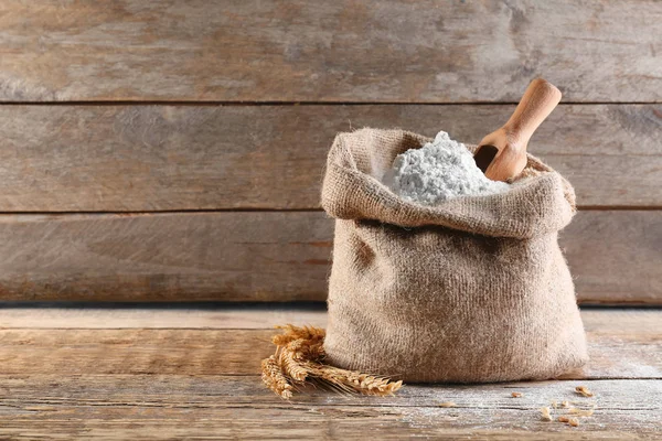 Scoop in sackcloth bag with flour — Stock Photo, Image