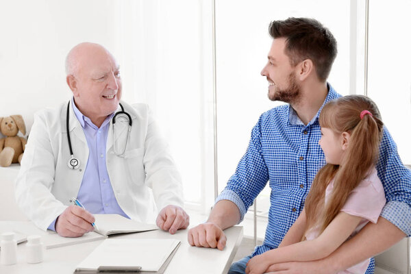 girl with father at doctor's office