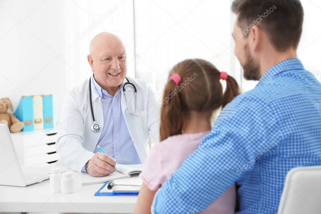 girl with father at doctor's office
