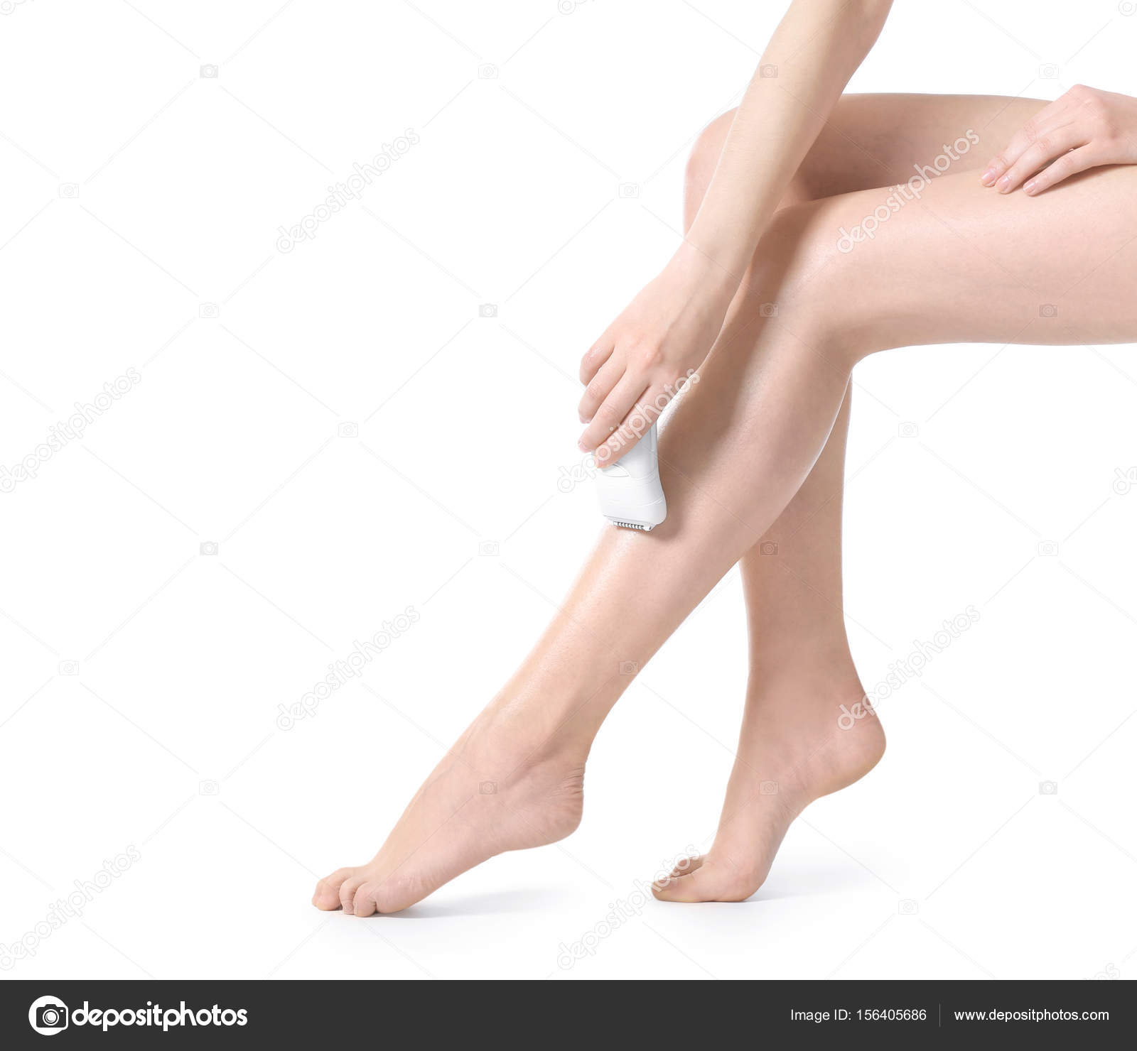 Beautiful young woman epilating legs — Stock Photo © belchonock 156405686