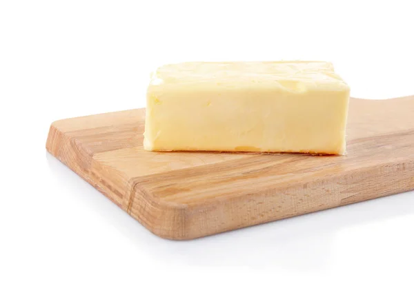 Wooden board with butter — Stock Photo, Image