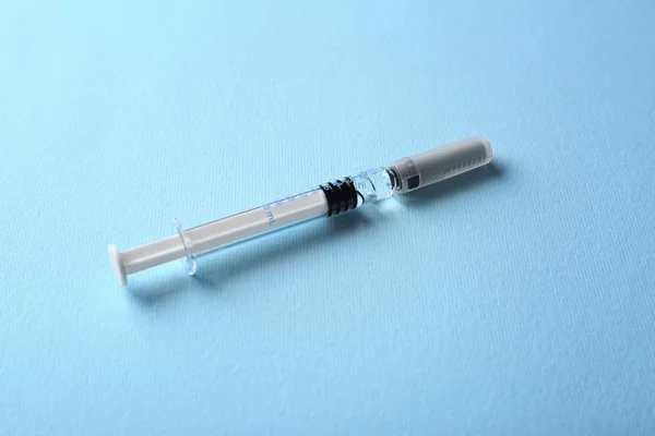 Medical syringe on blue — Stock Photo, Image