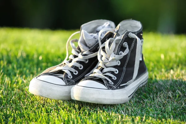 Pair of gumshoes on  grass — Stock Photo, Image