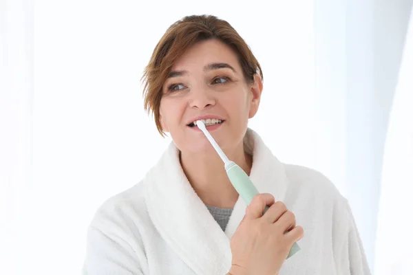 Senior woman cleaning teeth