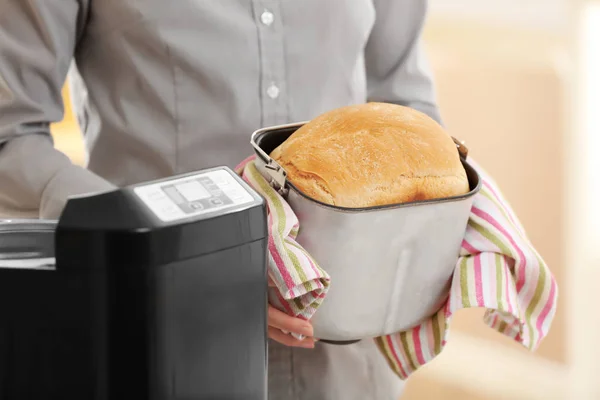 Woman holding bread machine