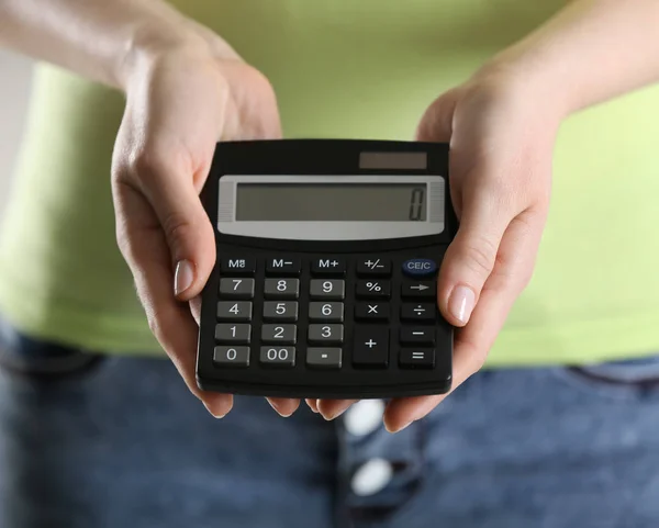 Woman holding calculator