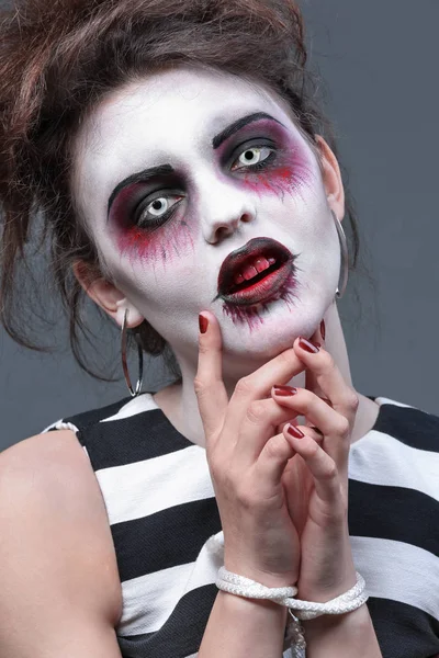Young woman in color contact lenses, with Halloween makeup on grey background, closeup — Stock Photo, Image