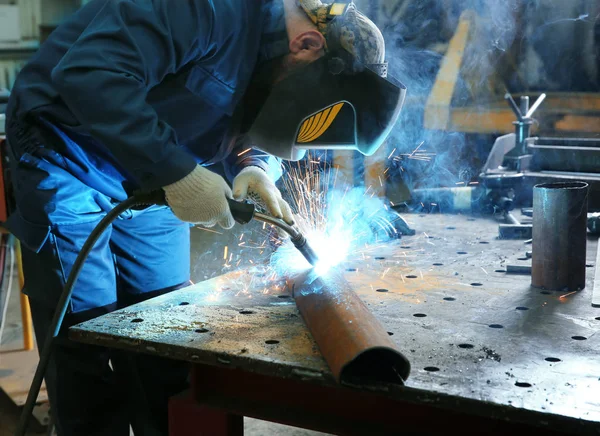 Arbetstagaren använder svetsutrustning för metallbearbetning — Stockfoto