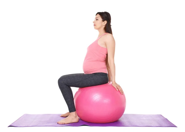 Mujer embarazada haciendo yoga —  Fotos de Stock