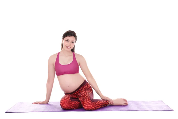 Mujer embarazada haciendo yoga —  Fotos de Stock