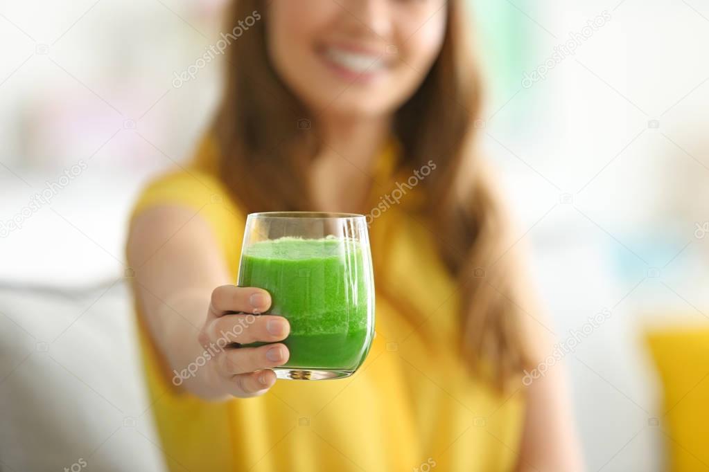 woman holding glass of smoothie