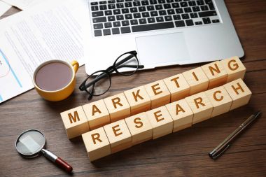 Metin pazarlama araştırması ile tahta küpleri ve masa üstünde laptop