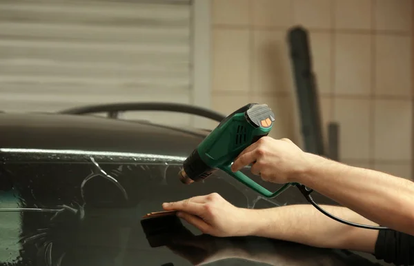 Worker applying tinting foil — Stock Photo, Image