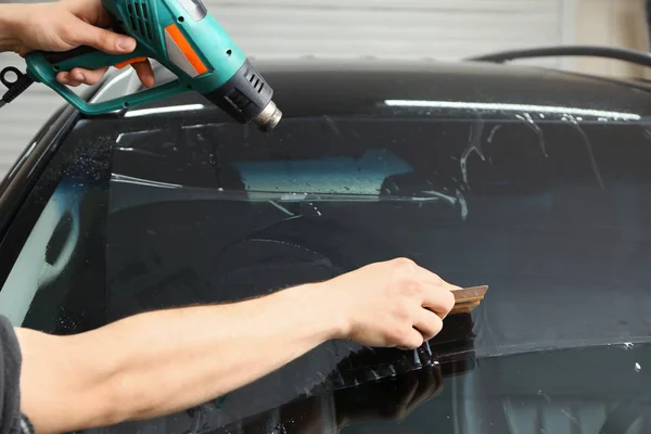 Worker applying tinting foil — Stock Photo, Image