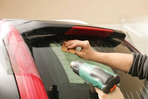 Worker applying tinting foil — Stock Photo, Image