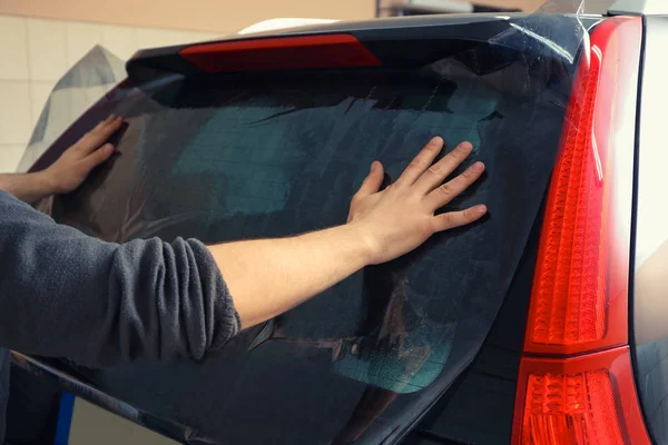 Worker applying tinting foil — Stock Photo, Image