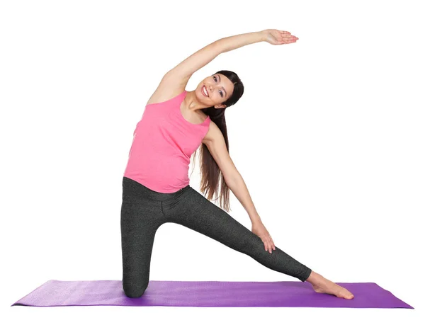 Mujer embarazada haciendo yoga —  Fotos de Stock