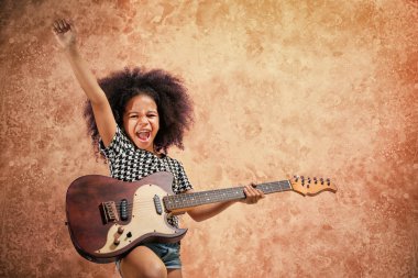 Afro-Amerikan küçük kız grunge özgeçmişlerine gitar çalmak