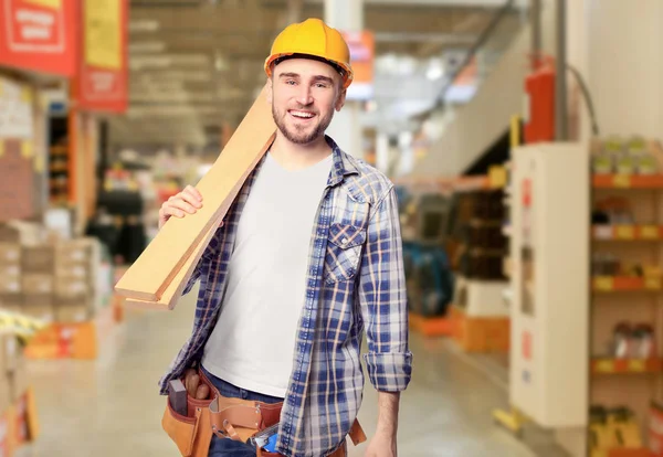 Carpenter holding wooden planks — Stock Photo, Image
