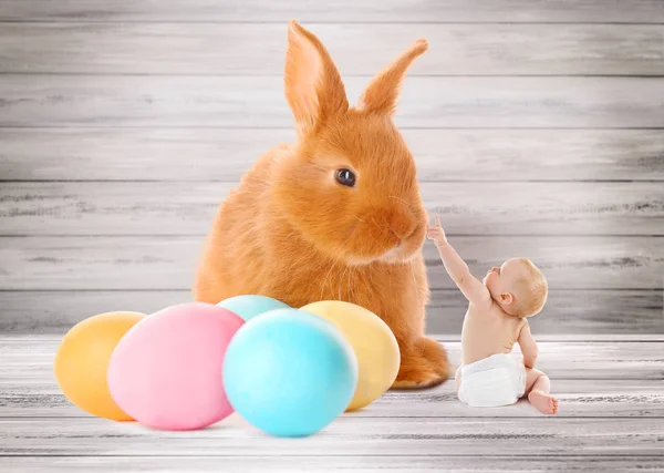 Tiny baby boy playing with bunny — Stock Photo, Image