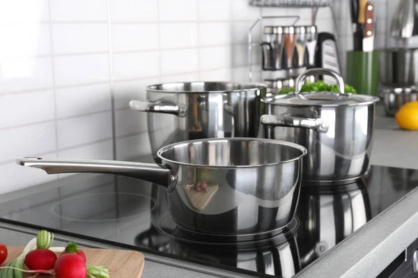 Utensils for cooking classes on electric stove in kitchen