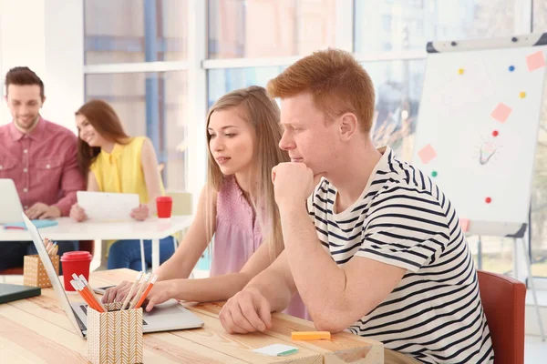 Junge Leute arbeiten im Büro mit Laptops — Stockfoto