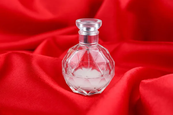 Perfume bottle on cloth — Stock Photo, Image