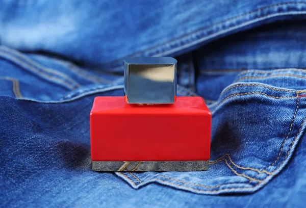 Perfume bottle on cloth — Stock Photo, Image