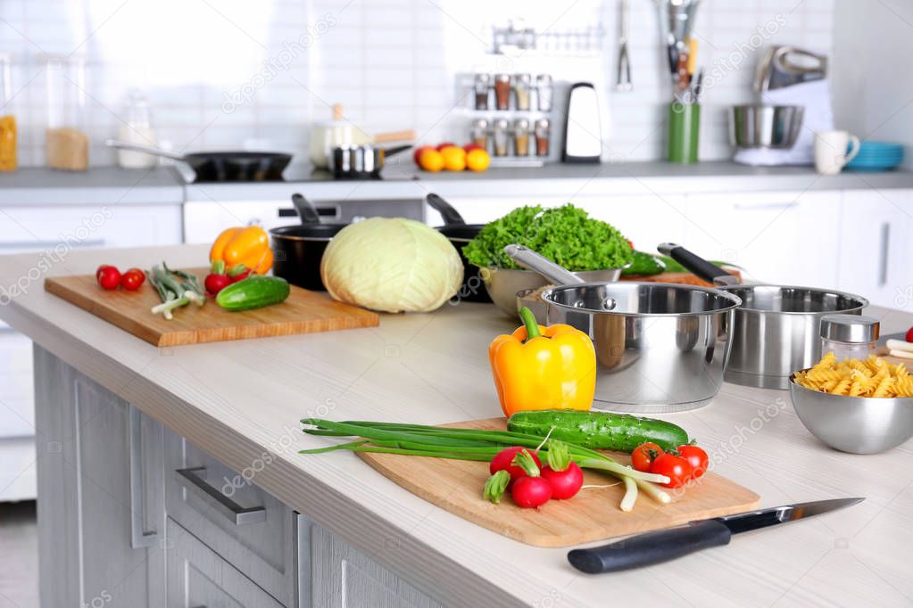 Fresh vegetables and utensils for cooking classes on wooden table