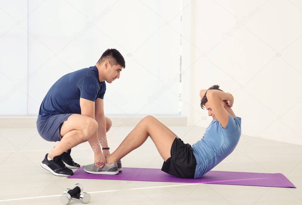 Dad and son training in gym