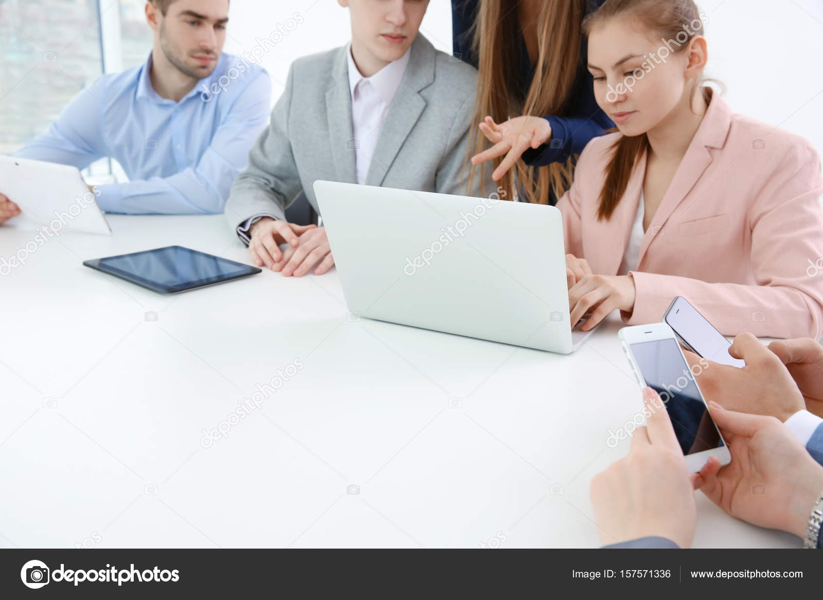 Team work concept. People sitting at table in office and using digital ...