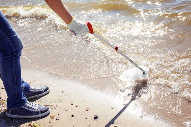 Genç çocuk çöp seçici ile plaj alanı Temizleme. Gönüllü kavramı