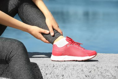 Bacağında ağrı olan bir kadın.