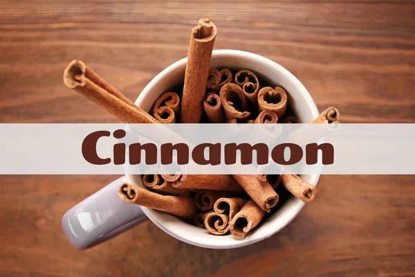 Cup with cinnamon sticks — Stock Photo, Image