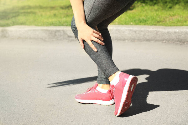 woman suffering from pain in leg