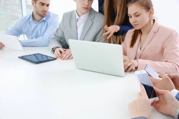 Concepto de trabajo en equipo. Personas sentadas a la mesa en la oficina y utilizando dispositivos digitales —  Fotos de Stock