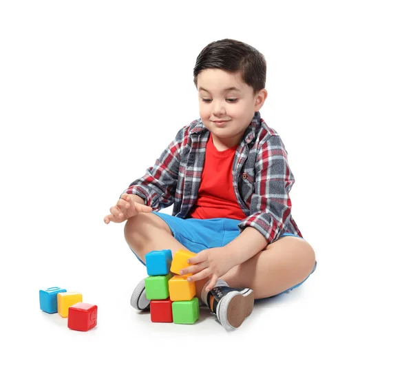 Lindo niño jugando con cubos de colores sobre fondo blanco — Foto de Stock