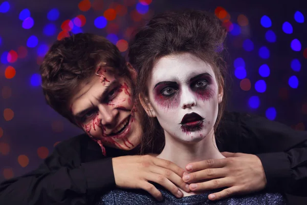 Young man and woman with Halloween makeup at party — Stock Photo, Image