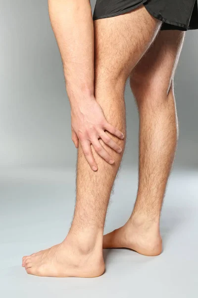 Man suffering from pain in leg — Stock Photo, Image