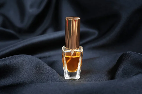 Perfume bottle on cloth — Stock Photo, Image